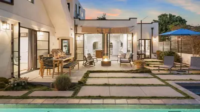 a patio with a table and chairs and a pool at Vista Del Mar by AvantStay Stunning Spanish Inspired Home w Pool Hot Tub Rooftop Patio in San Diego