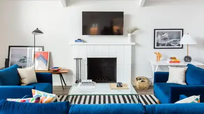 a living room with blue couches and a fireplace at Hamilton II by AvantStay Beach House Rooftop Deck Newly Renovated Bungalow in San Diego