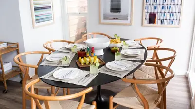 a black table with chairs and a plate of food at Hamilton II by AvantStay Beach House Rooftop Deck Newly Renovated Bungalow in San Diego