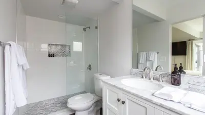 a white bathroom with a toilet and a sink at Hamilton I by AvantStay Beach House Rooftop Deck Newly Renovated Bungalow in San Diego