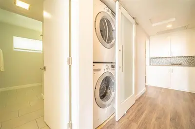 a laundry room with a washer and dryer at Hamilton I by AvantStay Beach House Rooftop Deck Newly Renovated Bungalow in San Diego