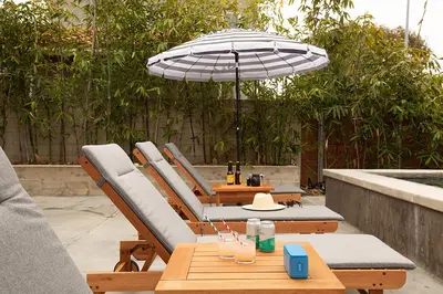 a patio with a table and chairs and an umbrella at Hamilton I by AvantStay Beach House Rooftop Deck Newly Renovated Bungalow in San Diego
