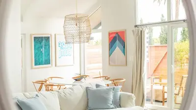 a living room with a white couch and a table at Hamilton I by AvantStay Beach House Rooftop Deck Newly Renovated Bungalow in San Diego