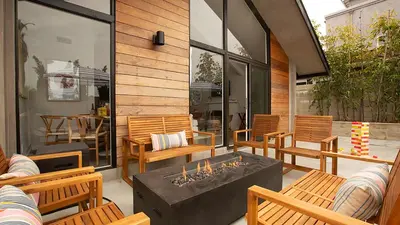 a patio with chairs and a table with a fireplace at Hamilton I by AvantStay Beach House Rooftop Deck Newly Renovated Bungalow in San Diego