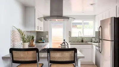 a kitchen with a refrigerator and two chairs in it at 3 Blocks to Beach Private Pool Rooftop Patio Hamilton I II by AvantStay in San Diego
