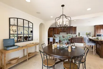 a dining room and kitchen with a table and chairs at Shoreline by AvantStay Spectacular Beachfront Home w Fire Pit Spa Pool Table in San Diego