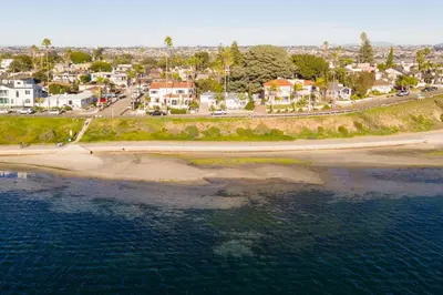 an aerial view of a beach with houses and the water at Kokomo by AvantStay Bayside Getaway w Fire Pit Large Outdoor Patio in San Diego