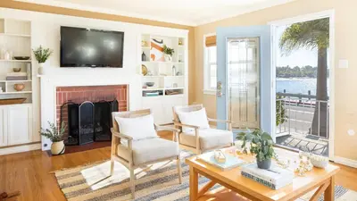 a living room with a fireplace and a tv at Kokomo by AvantStay Bayside Getaway w Fire Pit Large Outdoor Patio in San Diego