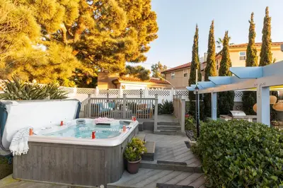 a hot tub in the backyard of a house at Kokomo by AvantStay Bayside Getaway w Fire Pit Large Outdoor Patio in San Diego