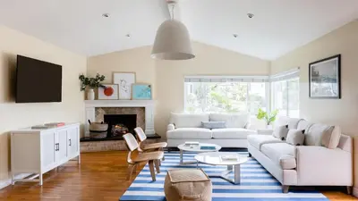 a living room with a white couch and a fireplace at Oliver by AvantStay Summer Escape Beach House 4 Blcks from Ocean in San Diego