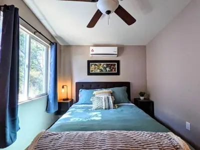 a bedroom with a bed with a ceiling fan at #6 The Hawks Hideout Cabin in Santa Ysabel