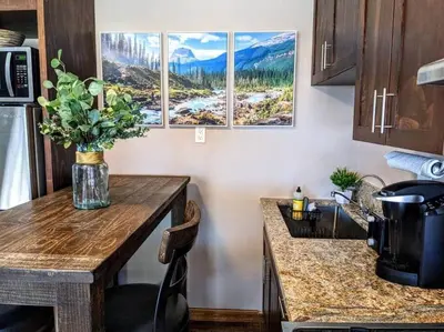 a kitchen with a table with a vase of flowers on it at #6 The Hawks Hideout Cabin in Santa Ysabel
