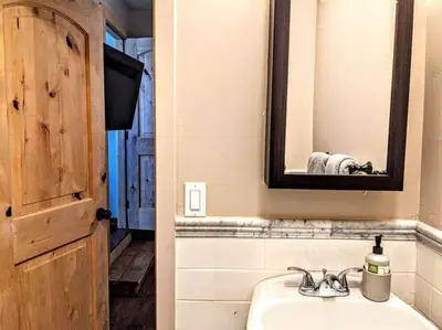 a bathroom with a sink and a mirror at #6 The Hawks Hideout Cabin in Santa Ysabel