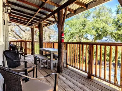 a porch with a table and chairs on a deck at #6 The Hawks Hideout Cabin in Santa Ysabel