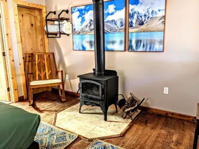 a fireplace in a room with a stove at Falcon's Chalet- Cabin in Santa Ysabel