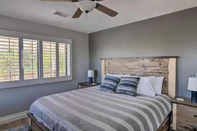 a bedroom with a bed and a ceiling fan at Hilltop Hideaway in Temecula Wine Country in Sage