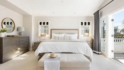 a white bedroom with a large bed and a window at Crystal Cove by AvantStay Gorgeous Charming Newport Home in Newport Beach