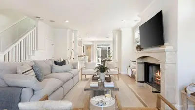 a living room with a couch and a fireplace at Crystal Cove by AvantStay Gorgeous Charming Newport Home in Newport Beach