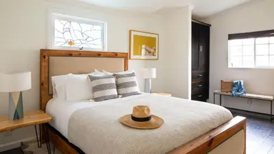 a bedroom with a bed with a hat on it at Sand Castle by AvantStay Beach House on Balboa Peninsula w Patio Hot Tub in Newport Beach