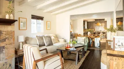 a living room with a couch and a table at Sand Castle by AvantStay Beach House on Balboa Peninsula w Patio Hot Tub in Newport Beach