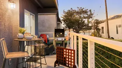 a balcony with a table and a stove at Mission Point Buyout by AvantStay Two Unit Buyout w Patio Fire Pit Close to Beach 6BDRs in San Diego