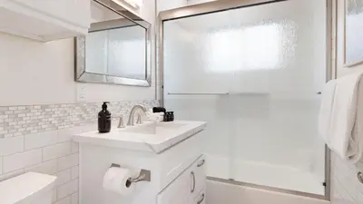a white bathroom with a sink and a shower at Mission Point Buyout by AvantStay Two Unit Buyout w Patio Fire Pit Close to Beach 6BDRs in San Diego