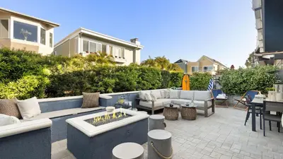a patio with couches and a fire pit at Mission Point Buyout by AvantStay Two Unit Buyout w Patio Fire Pit Close to Beach 6BDRs in San Diego