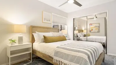 a white bedroom with a bed and a mirror at Mission Point Buyout by AvantStay Two Unit Buyout w Patio Fire Pit Close to Beach 6BDRs in San Diego