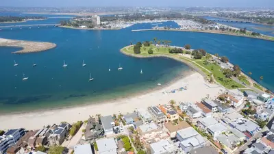 an aerial view of a beach with boats in the water at Mission Point 1 by AvantStay San Diego Beach House w Huge Patio Fire Pit Walk to Beach in San Diego