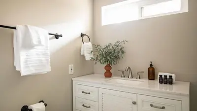 a white bathroom with a sink and a window at Chateau Syrah by AvantStay Picturesque Estate w Pool Hot Tub Table Tennis Pool Table New Pickleball Court Basketball hoop in Temecula
