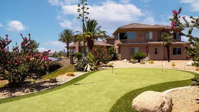 a golf course in front of a house at Sangiovese By AvantStay Spectacular Estate w Pool Hot Tub Putting Green in Temecula