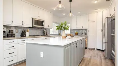 a kitchen with white cabinets and a white counter top at The Riesling Retreat by AvantStay Estate w Pool HotTub Putting Green Pickle Ball Court in Sage