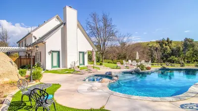 a house with a swimming pool in a yard at The Riesling Retreat by AvantStay Estate w Pool HotTub Putting Green Pickle Ball Court in Sage