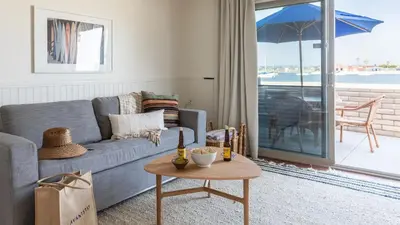 a living room with a couch and a table at Bay View II by AvantStay Ocean View Mission Beach Home on the Sand in San Diego