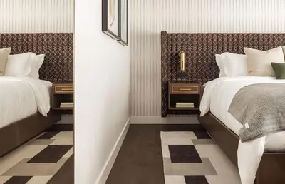 a bedroom with two beds and two night stands at Orli La Jolla in San Diego