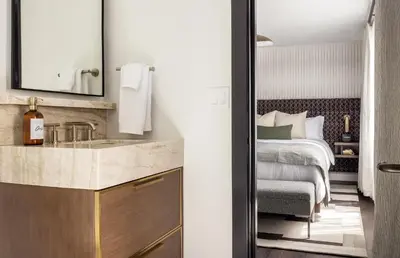 a bathroom with a sink and a bed in a room at Orli La Jolla in San Diego