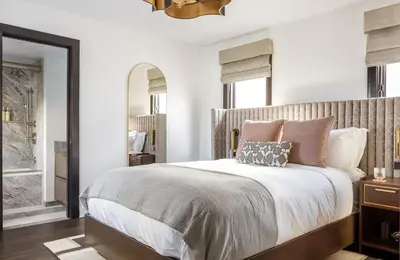 a bedroom with a large bed with pillows on it at Orli La Jolla in San Diego