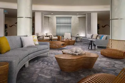 a lobby with couches and tables and chairs at Pier South Resort, Autograph Collection in Imperial Beach