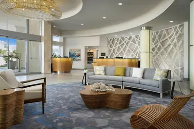 a lobby with a couch and chairs and a table at Pier South Resort, Autograph Collection in Imperial Beach