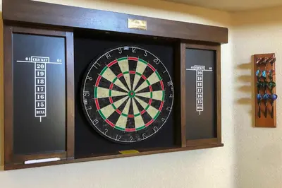 a dart board on a wall with some darts at Borrego Springs Retreat with Grill and Patio! in Borrego Springs