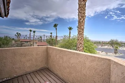 a balcony with a wall with a palm tree at Borrego Springs Retreat with Grill and Patio! in Borrego Springs
