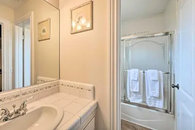 a white bathroom with a sink and a shower at Luxe Vista Getaway with Private Pool and Hot Tub! in Vista