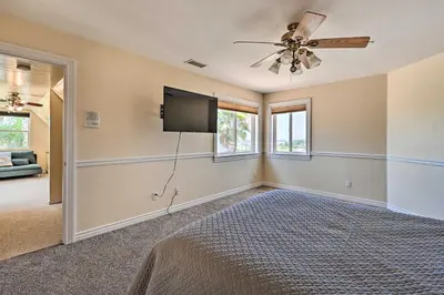 a bedroom with a bed and a flat screen tv at Luxe Vista Getaway with Private Pool and Hot Tub! in Vista