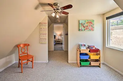 a hallway with a ceiling fan and a chair at Luxe Vista Getaway with Private Pool and Hot Tub! in Vista