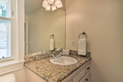 a bathroom with a sink and a mirror at Luxe Vista Getaway with Private Pool and Hot Tub! in Vista
