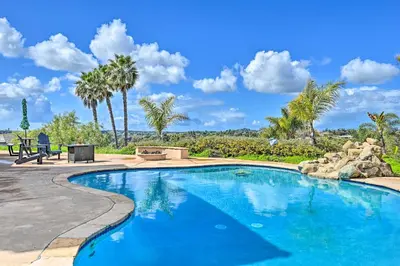 a swimming pool with a picnic table and palm trees at Luxe Vista Getaway with Private Pool and Hot Tub! in Vista