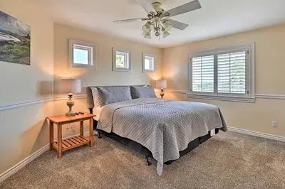 a bedroom with a bed and a ceiling fan at Luxe Vista Getaway with Private Pool and Hot Tub! in Vista