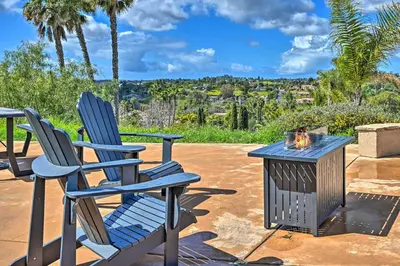 two chairs and a fire pit on a patio at Luxe Vista Getaway with Private Pool and Hot Tub! in Vista