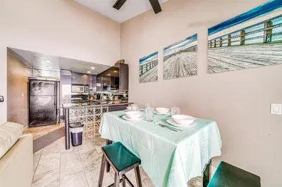 a dining room with a table and green chairs at Whitewater Village Charm in Oceanside