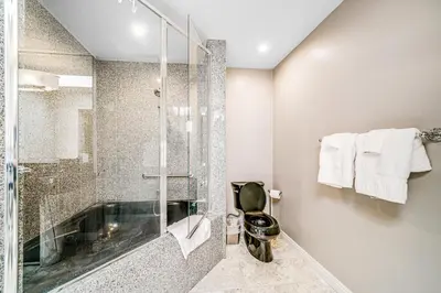 a bathroom with a glass shower and a tub at Whitewater Village Charm in Oceanside